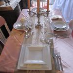 Beautiful Antique Rose Satin Overlay  on a Ivory Table Cloth with a Burlap Runner and a added touch of elegance with a Lace smaller runner. Our plate styles compliment any setting.