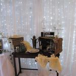Our Vintage Display, with glasses, lace and linen, in front of the beautiful backdrop