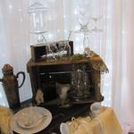 Our Vintage Display, with glasses, lace, plates and linen, in front of the beautiful backdrop